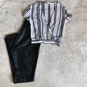 Cropped, navy blue and white v-neck shirt.